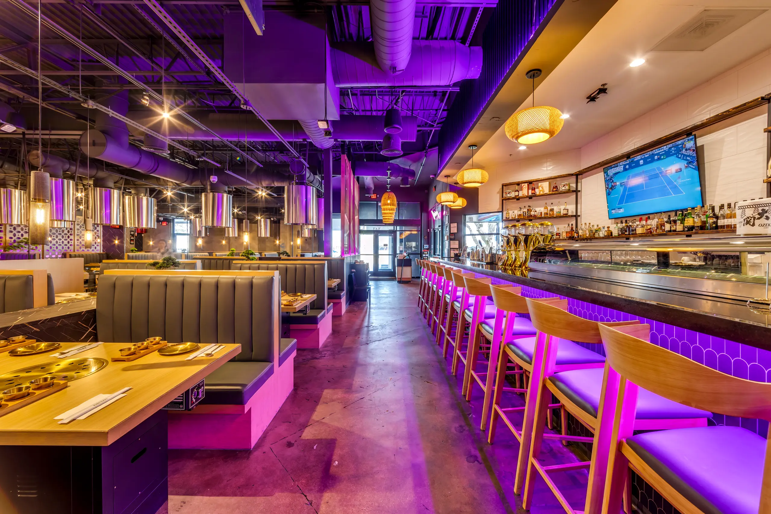 Kauboi BBQ bar and booth seating with warm finishes